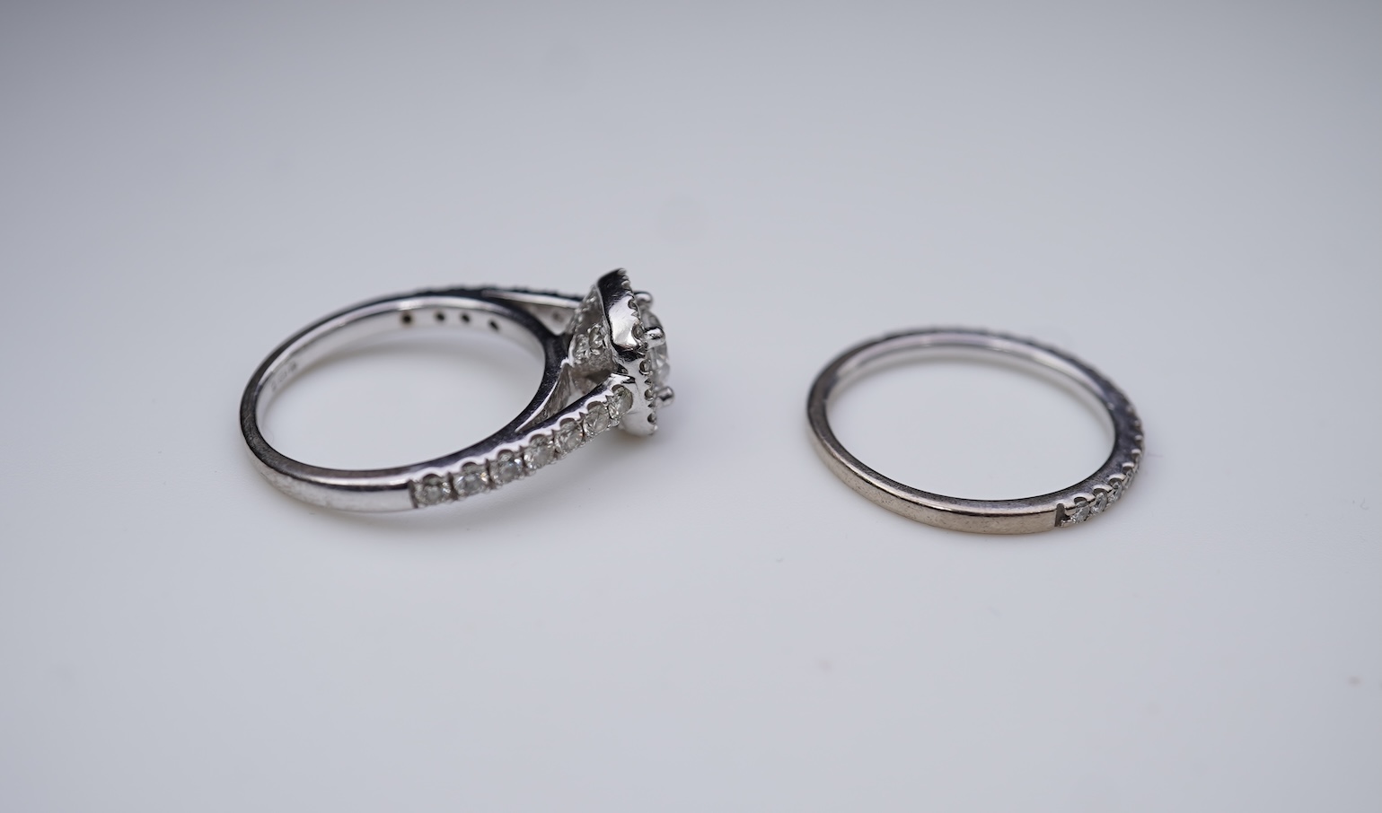 A diamond engagement ring and half eternity ring